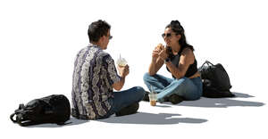 backlit sitting couple eating lunch on the street