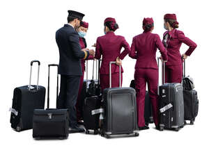 flight crew with a pilot and flight attendants with suitcases standing