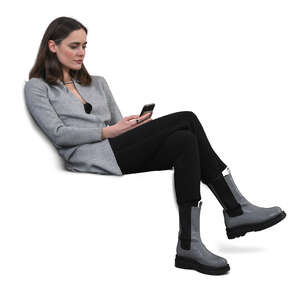 cut out woman sitting on a sofa and texting