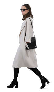 woman in a white overcoat walking