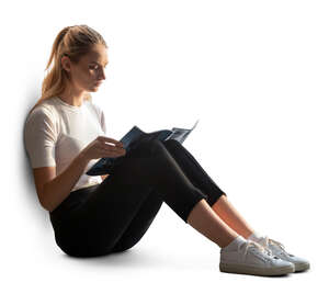 woman sitting by the window and reading a magazine