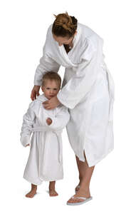 mother and son in white spa bathrobes standing