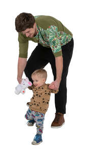 man helping his little son walk down the stairs