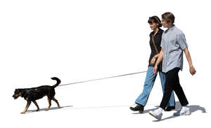 teenage couple with a dog walking