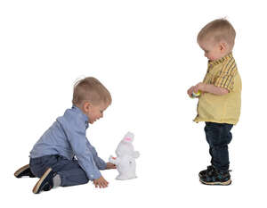 two boys playing with a toy rabbit