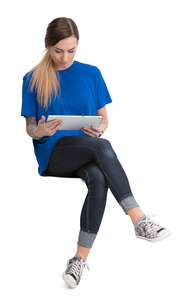 woman sitting and reading a tablet