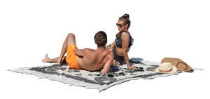 couple sunbathing and talking on the beach