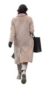 woman in a light beige overcoat walking