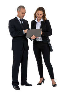 two office workers standing and looking at laptop