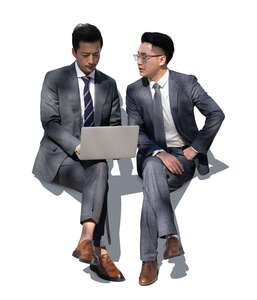 two asian businessmen sitting and discussing