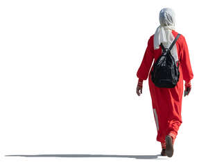 sidelit muslim woman with hijab walking