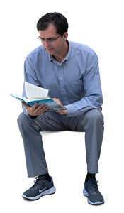 man sitting and reading a book