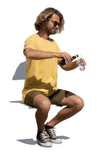 man sitting and drinking beer