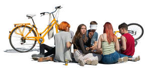 group of teenagers sitting on the ground