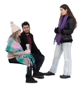 two people sitting and talking to a woman standing in front of them