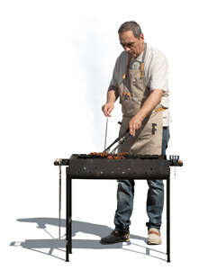man cooking over an outdoor grill