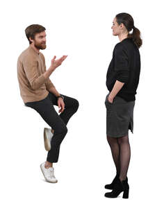 man sitting on a table and talking to a woman