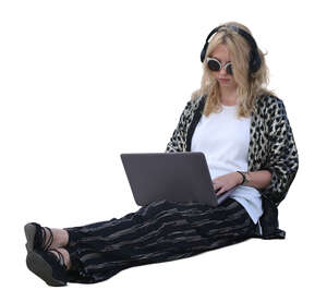woman with a laptop sitting on the ground
