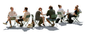 backlit outdoor cafe scene with people sitting and talking