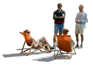 two men talking to two girls sitting in garden chairs