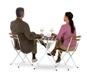 man and woman sitting in a restaurant seen from back angle