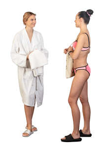 two women in a spa in bathing suits standing and talking