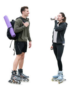 man and woman with rollerblades standing and resting