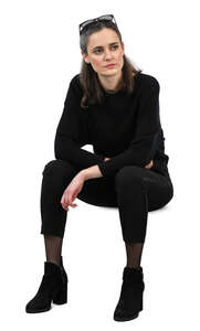 woman in a black outfit sitting