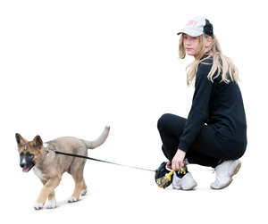 girl with a puppy squatting