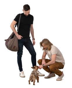 two men and a little dog standing