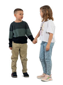 two kids standing and holding hands