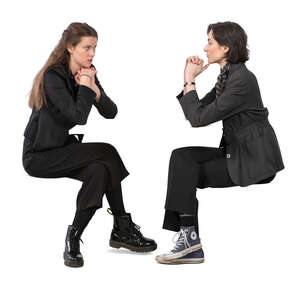 two women sitting and talking