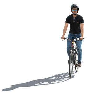 backlit man with a helmet riding a bike