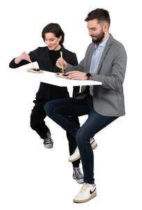 man and woman sitting in a restaurant and eating sushi