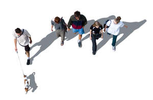 group of people and a dog walking seen from above