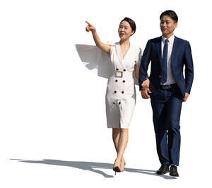 asian man and woman walking hand in hand