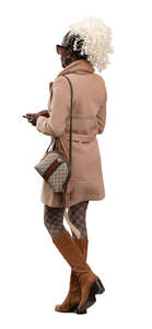 black woman in a trendy brown overcoat walking