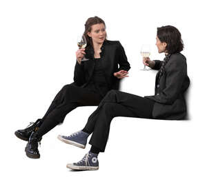 two women sitting and drinking wine and talking