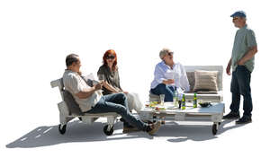 backlit group of older people relaxing in the garden