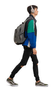 young man with headphones and backpack walking