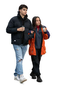 young couple in autumg walking and drinking coffee