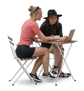 two young women sitting nad looking at a laptop