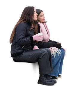 two women sitting outside in winter