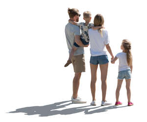 backlit family with two kids standing