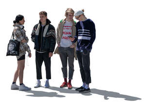 backlit group of teenagers standing