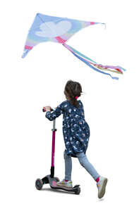 little girl with a kite riding a scooter