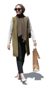 elegant muslim woman with shopping bags walking