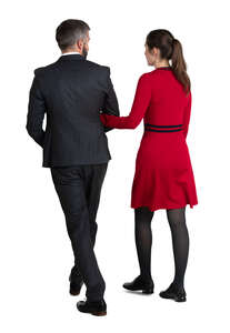 couple in suit and dress walking arm in arm