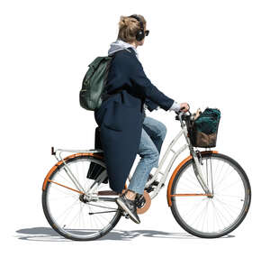 woman with headphones riding a city bike