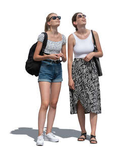 two young women standing and looking up